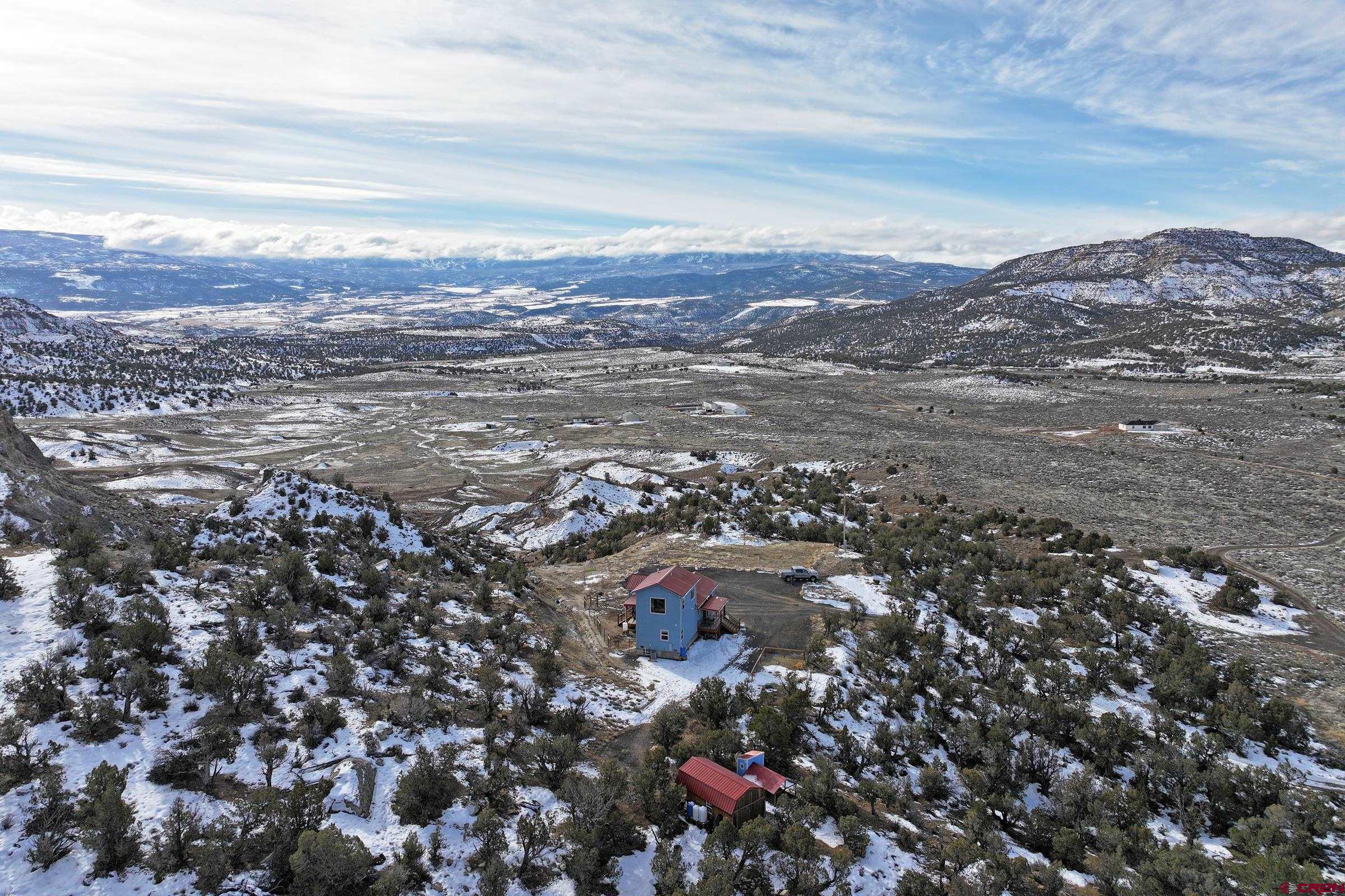 15086 45 45 1/2 Road De Beque, CO 81630 - Photo 32 of 40 an aerial view of residential building and trees around
