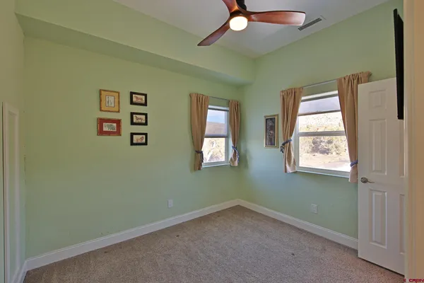 a view of walk in closet with empty racks