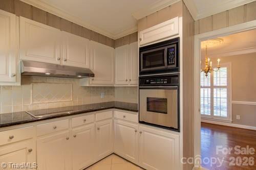 1405 Lyndhurst Drive High Point, NC 27262 - Photo 8 of 40 a kitchen with granite countertop a stove top oven microwave and cabinets