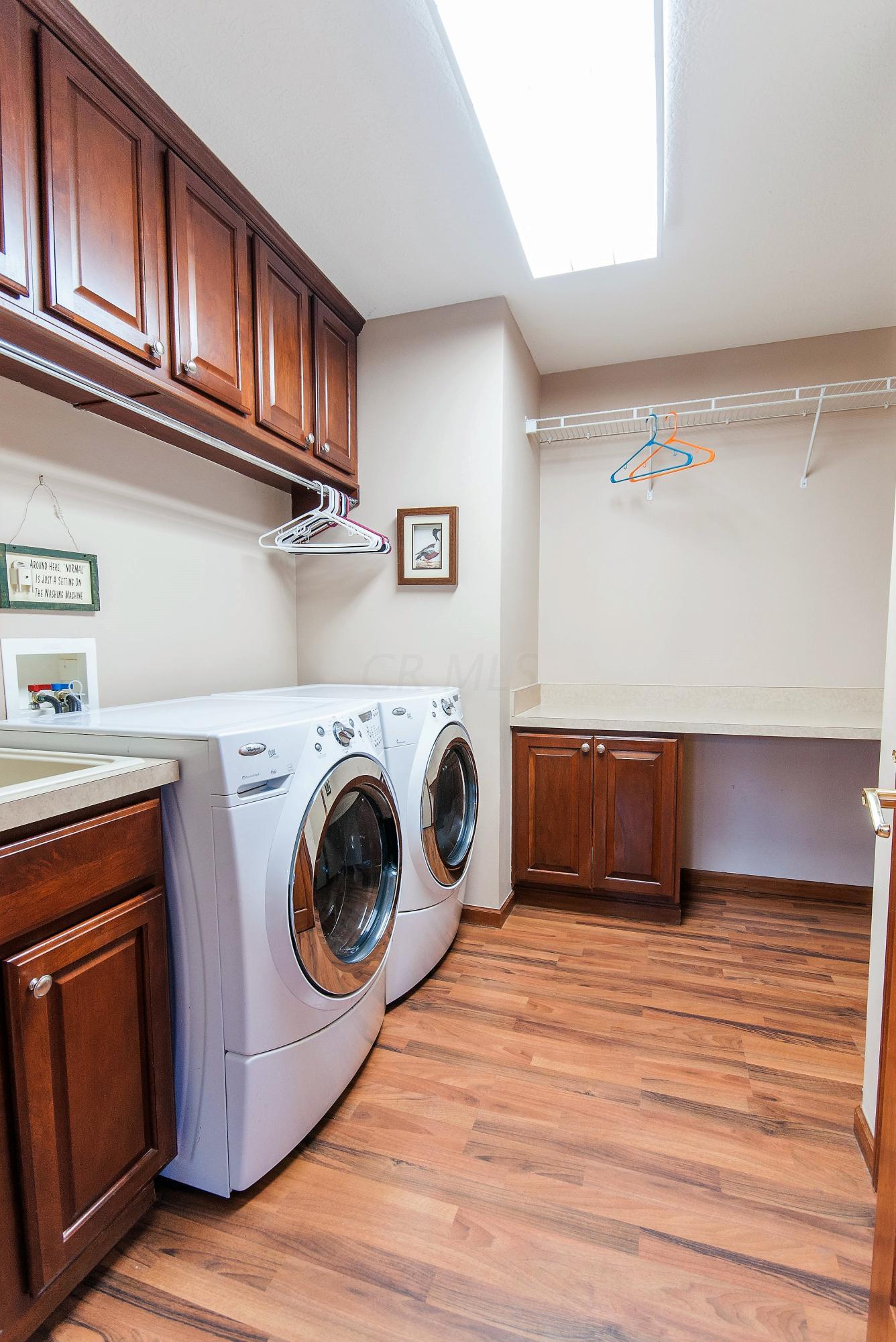 6305 Darling Road Blacklick, OH 43004 - Photo 39 of 58 1st floor laundry room with ample cabinets, folding table, coat closet and sink