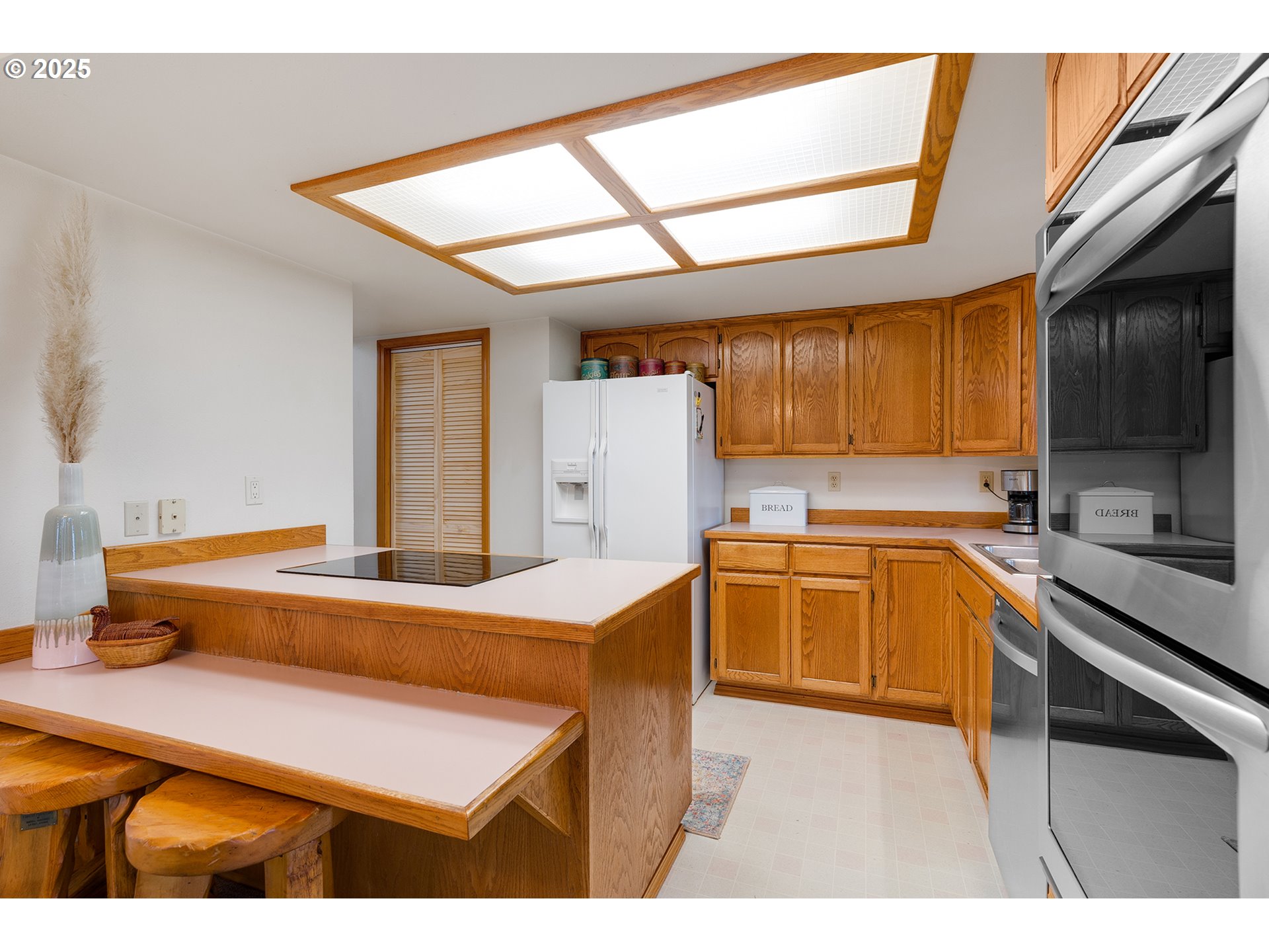 14018 South Spangler Road Oregon City, OR 97045 - Photo 13 of 34 a kitchen with wooden cabinets and refrigerator