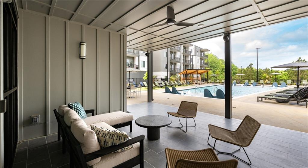 6000 Ava Avenue, Unit 4207 Gainesville, GA 30504 - Photo 21 of 34 a living room with furniture and a floor to ceiling window
