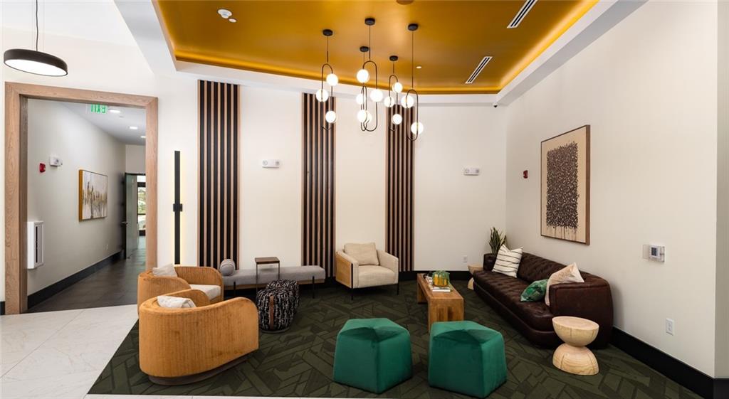 6000 Ava Avenue, Unit 4207 Gainesville, GA 30504 - Photo 24 of 34 a living room with furniture and a chandelier