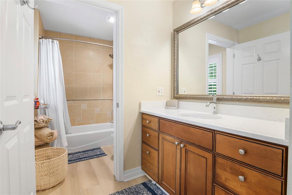 7600 Sandy Ridge Drive, Unit 204 Reunion, FL 34747 - Photo 12 of 39 a bathroom with a tub sink and mirror