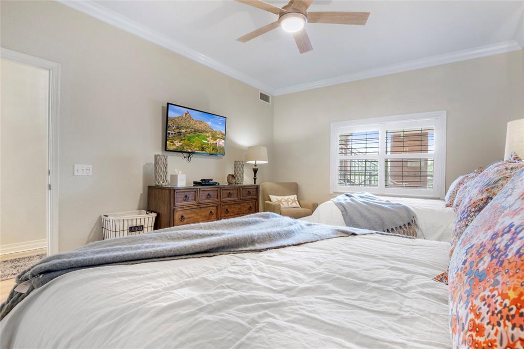 7600 Sandy Ridge Drive, Unit 204 Reunion, FL 34747 - Photo 23 of 39 a bedroom with a bed and a chandelier
