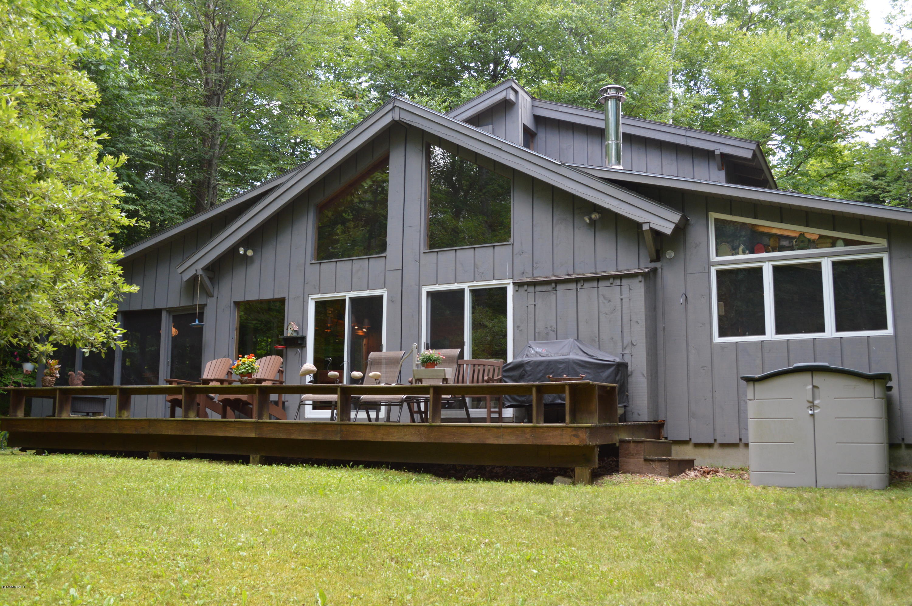 a front view of house with yard outdoor seating and yard in the back