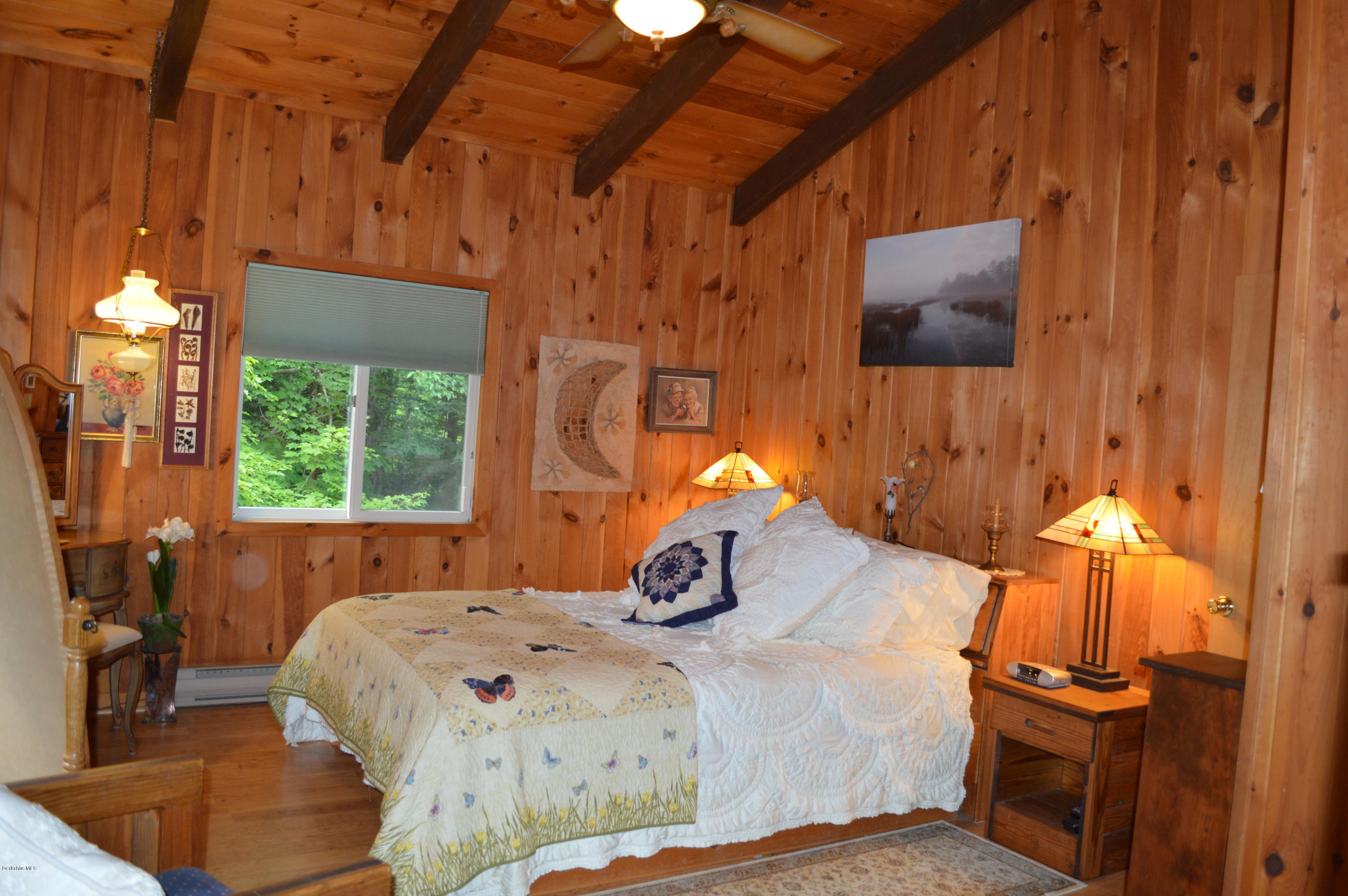 325 Bonny Rigg Hill Road Becket, MA 01223 - Photo 16 of 47 a bedroom with a bed and wooden floor