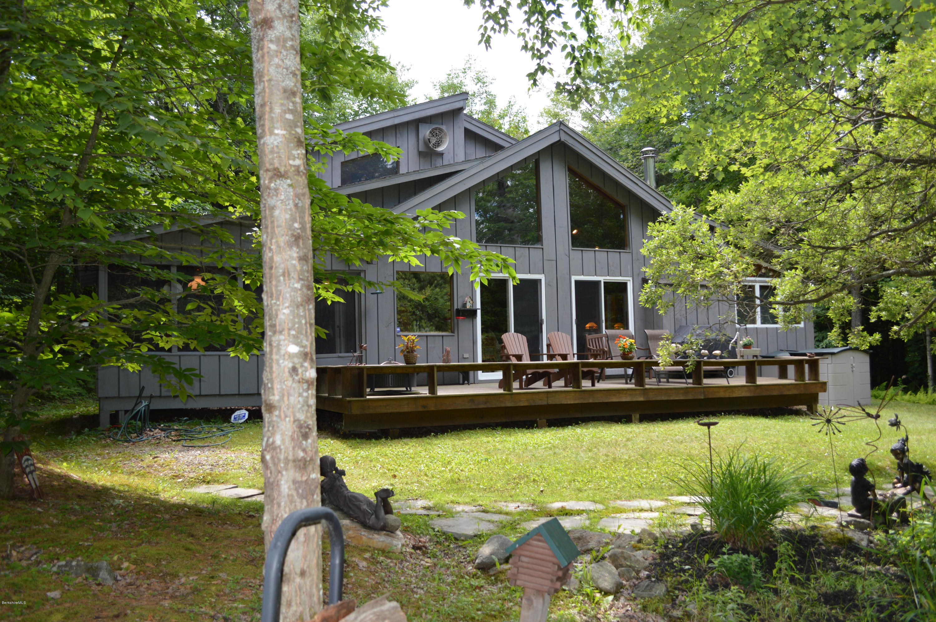 325 Bonny Rigg Hill Road Becket, MA 01223 - Photo 3 of 47 a view of a house with backyard swimming pool and sitting area