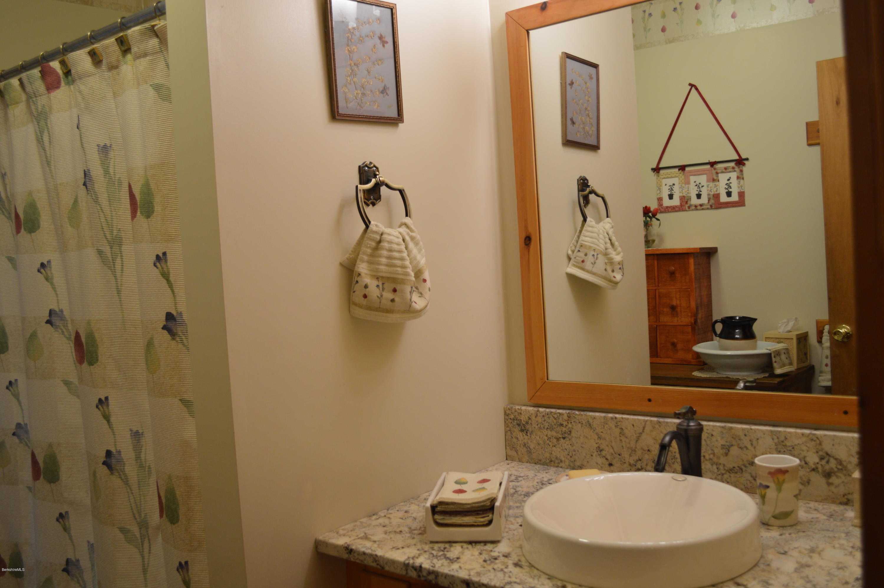 325 Bonny Rigg Hill Road Becket, MA 01223 - Photo 25 of 47 a bathroom with a sink a mirror and a shower curtain