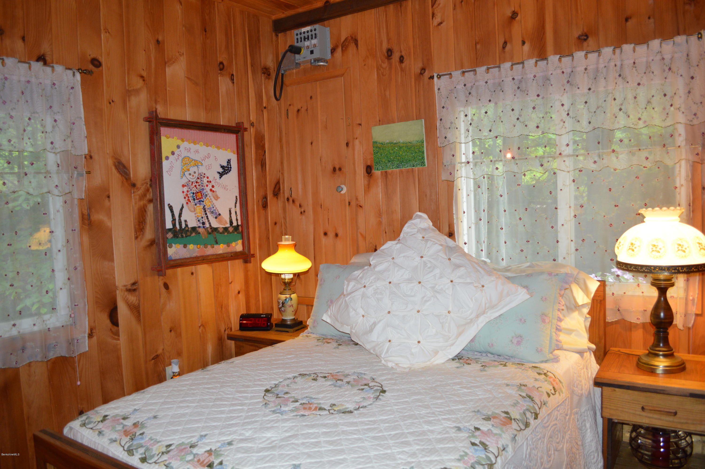 325 Bonny Rigg Hill Road Becket, MA 01223 - Photo 28 of 47 a bed room with a bed and a painting on the wall