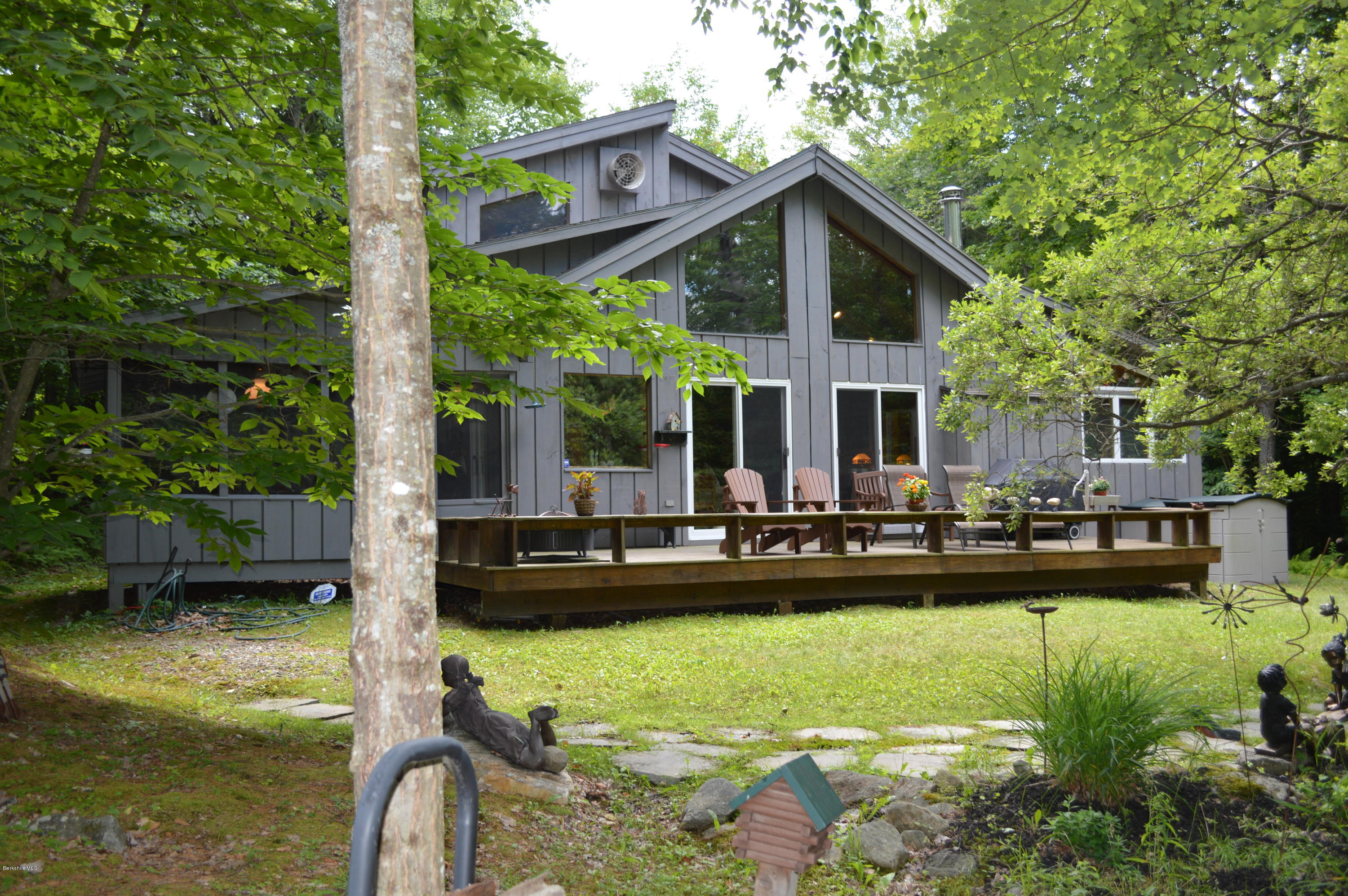 325 Bonny Rigg Hill Road Becket, MA 01223 - Photo 36 of 47 a front view of a house with swimming pool and garden