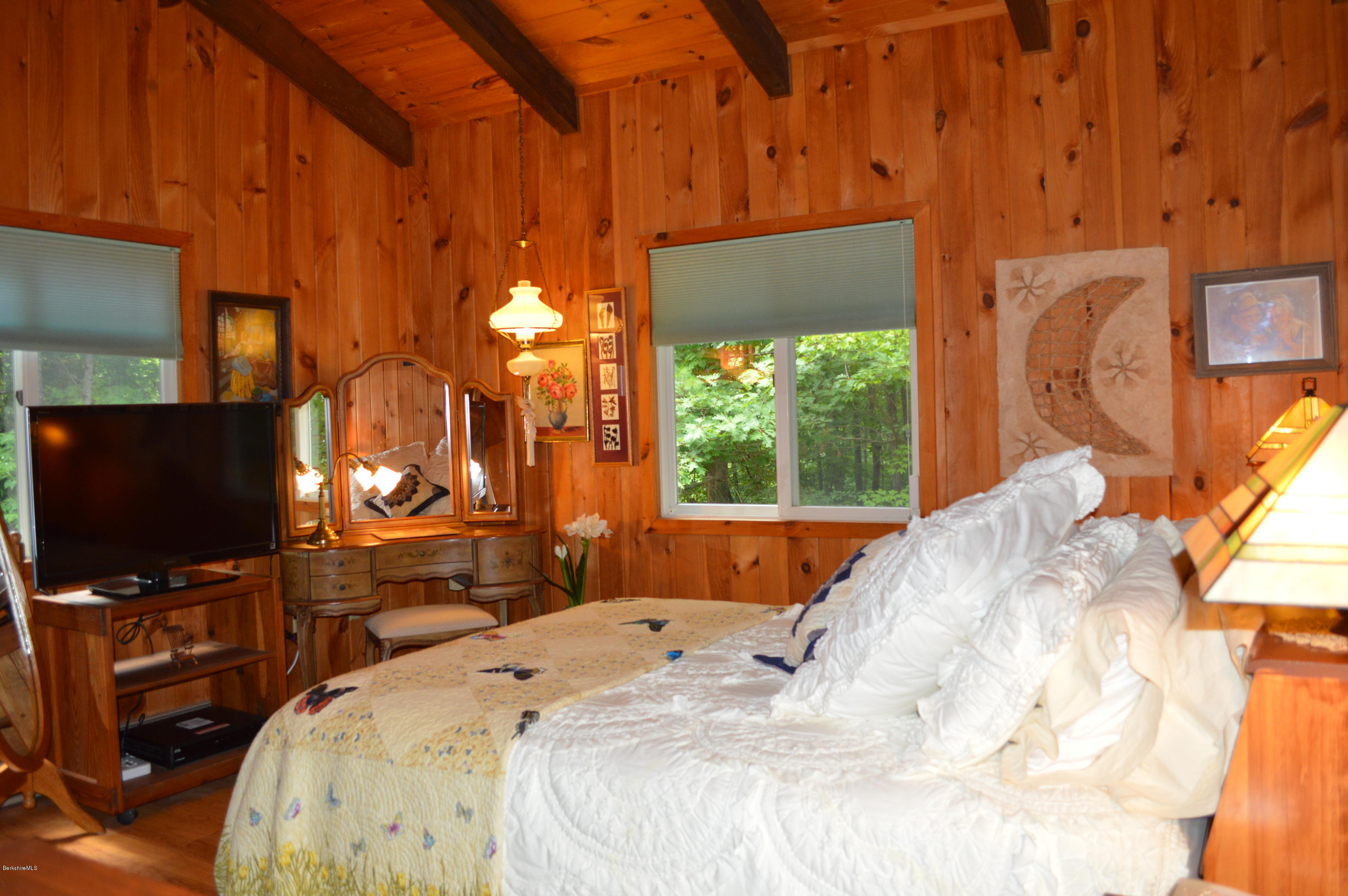 325 Bonny Rigg Hill Road Becket, MA 01223 - Photo 9 of 47 a bedroom with a bed and a flat tv screen on dresser