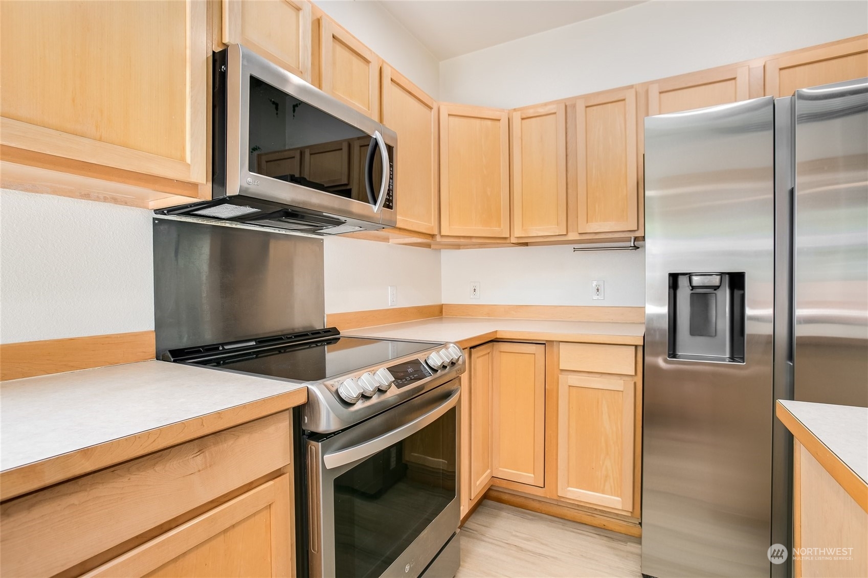 4109 South 220th Place, Unit 18 Kent, WA 98032 - Photo 11 of 29 a kitchen with a stove and a microwave
