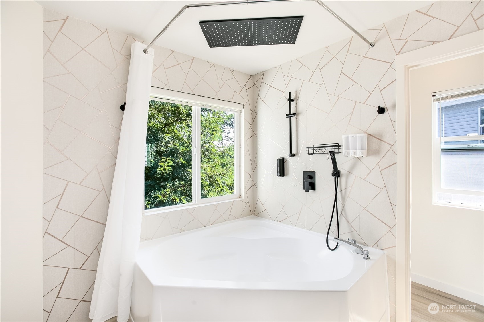 4109 South 220th Place, Unit 18 Kent, WA 98032 - Photo 16 of 29 a white bath tub sitting in a bathroom next to a window