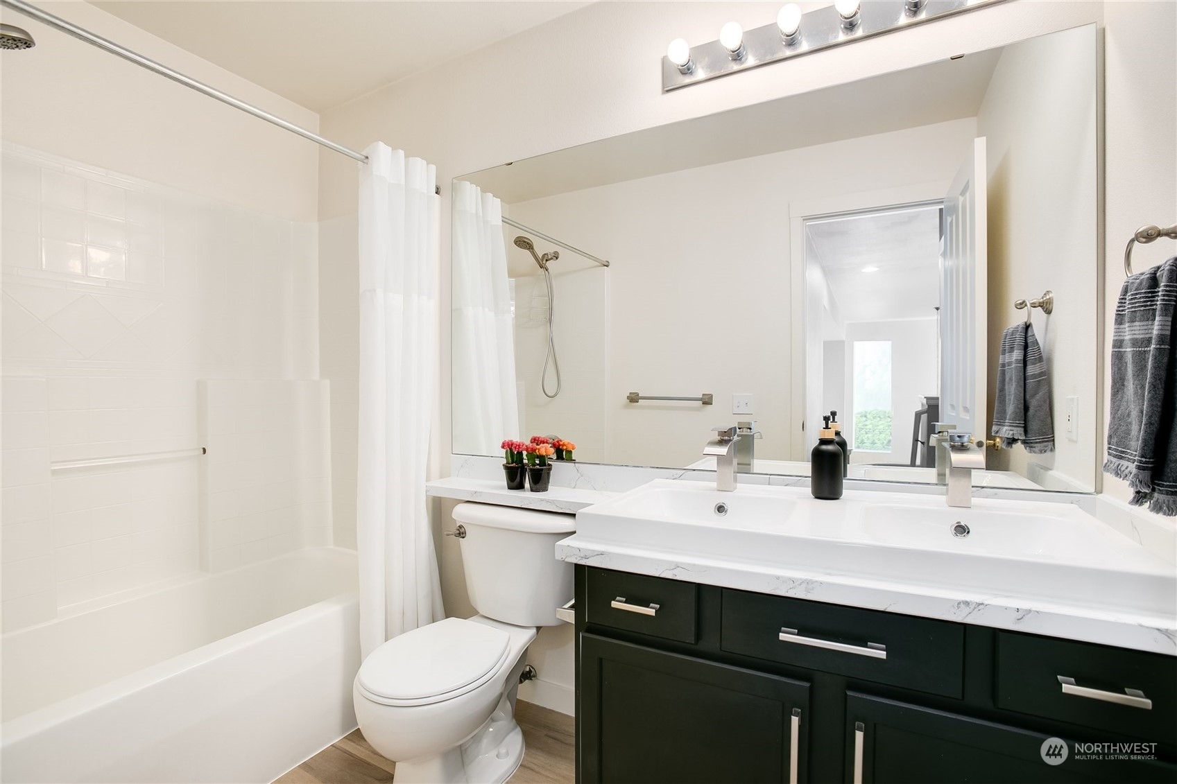 4109 South 220th Place, Unit 18 Kent, WA 98032 - Photo 20 of 29 a bathroom with a sink a toilet a mirror and a bathtub