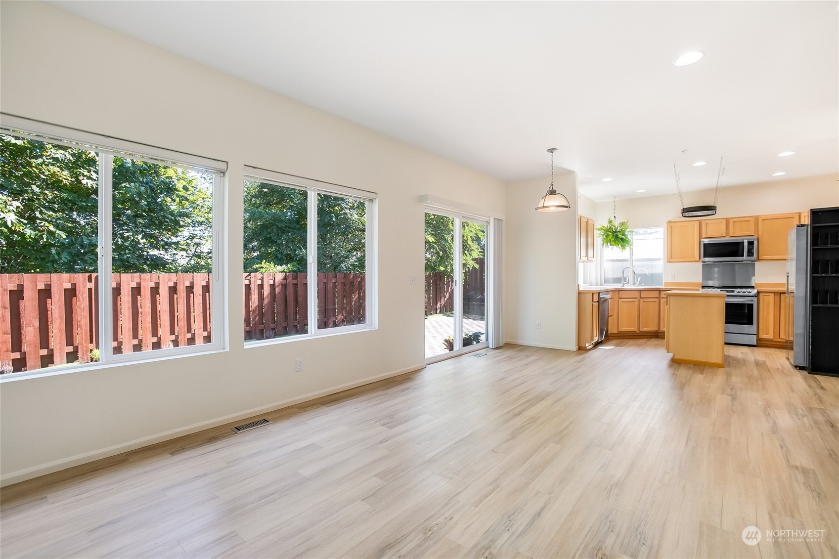 4109 South 220th Place, Unit 18 Kent, WA 98032 - Photo 6 of 29 an empty room with wooden floor and windows