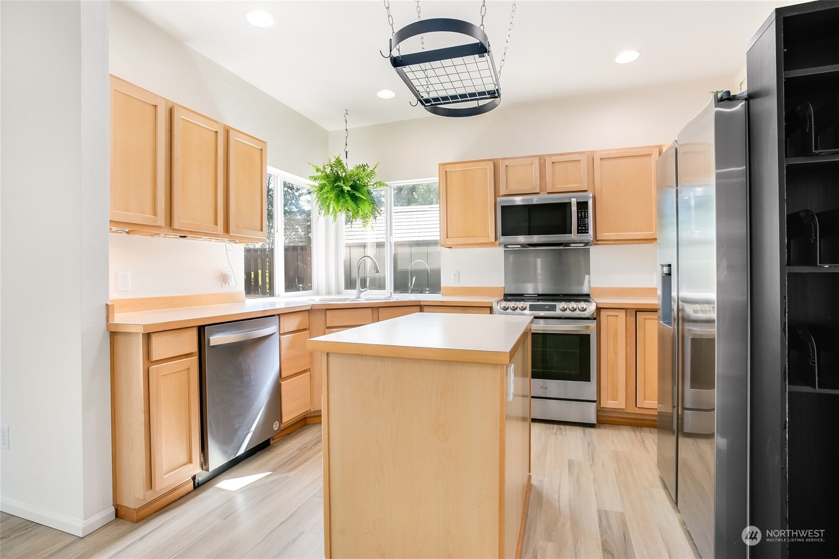 4109 South 220th Place, Unit 18 Kent, WA 98032 - Photo 9 of 29 a kitchen with stainless steel appliances granite countertop a refrigerator and a sink