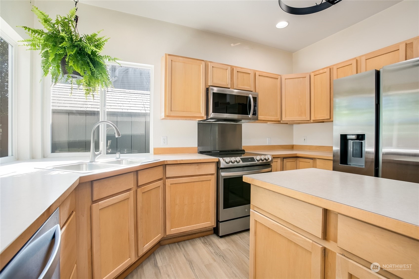 4109 South 220th Place, Unit 18 Kent, WA 98032 - Photo 10 of 29 a kitchen with a sink a stove and refrigerator