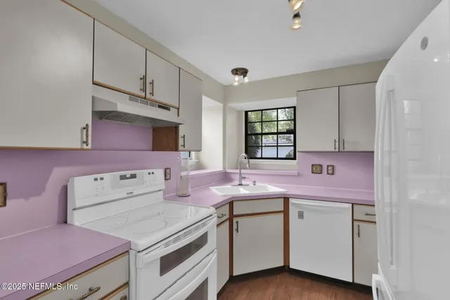 a kitchen with a sink stove and cabinets