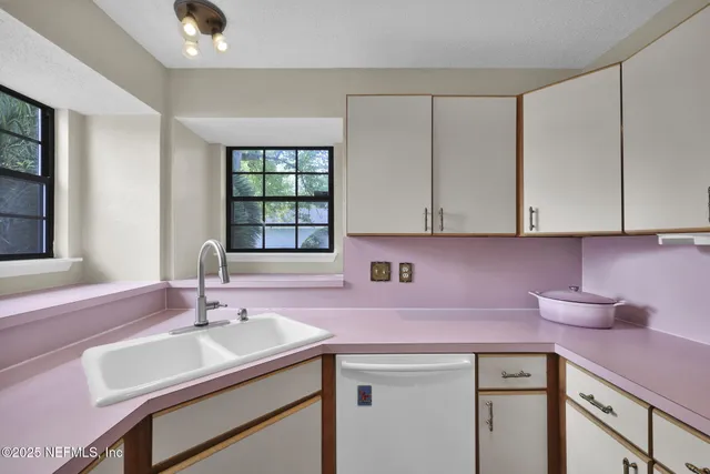 a kitchen with a sink cabinets and window