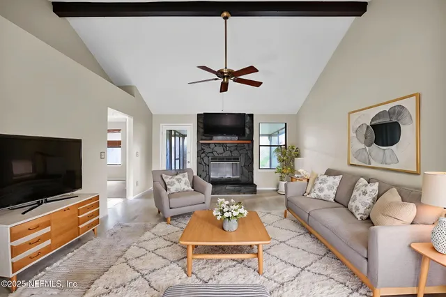 a living room with furniture and a flat screen tv