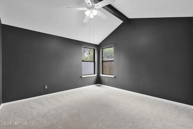 a view of a livingroom with a ceiling fan and window