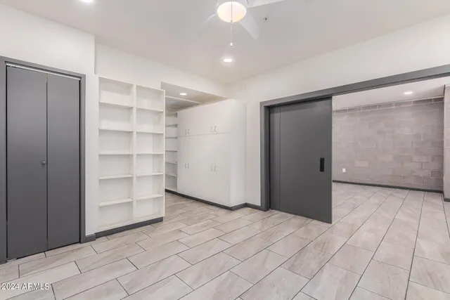 a view of an empty room with a cabinet and a window