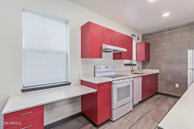 a kitchen with a sink stove and cabinets