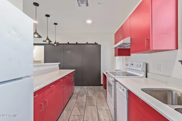a kitchen with a sink stove and cabinets
