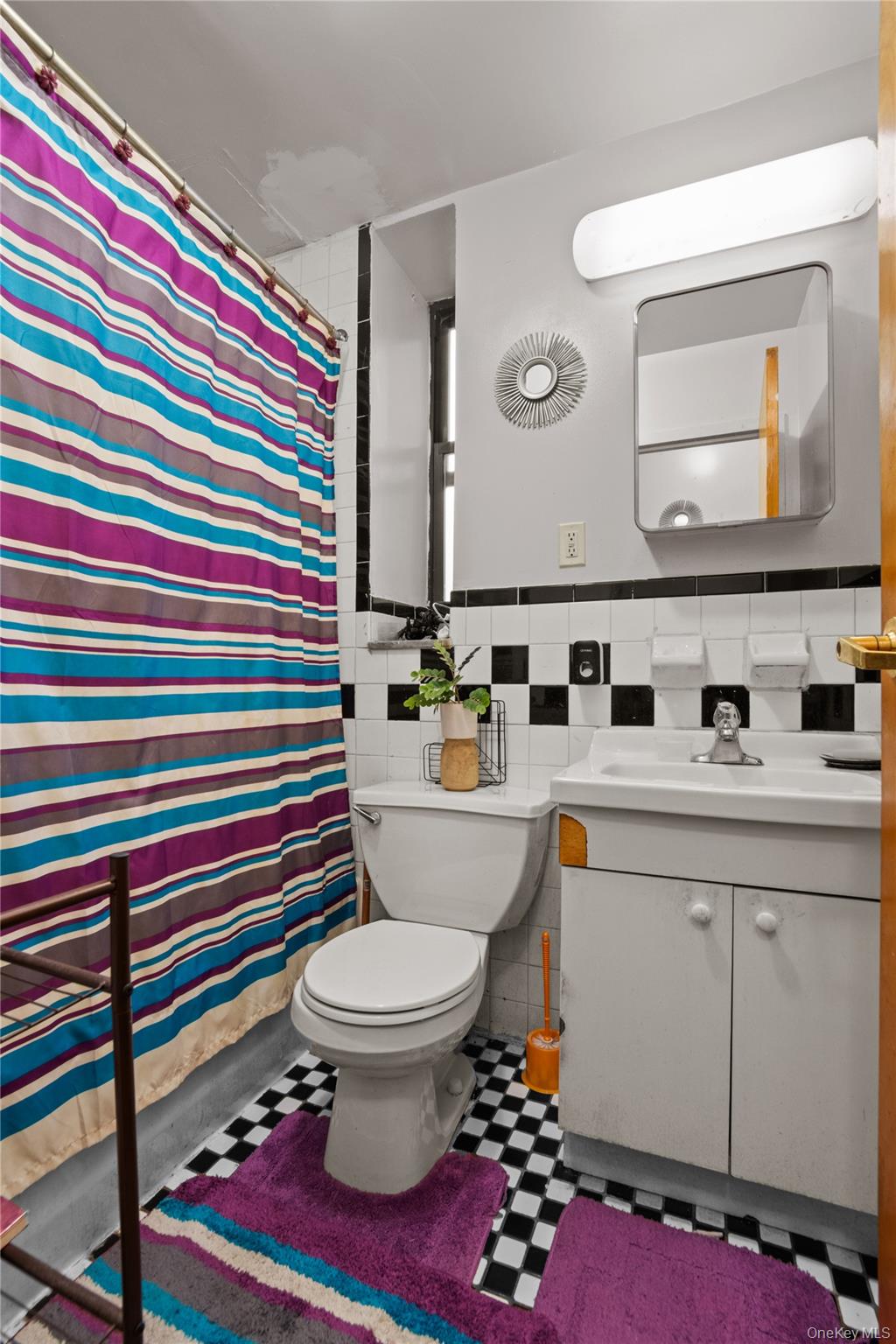 211 West 144th Street, Unit 2C Manhattan, NY 10030 - Photo 11 of 14 Full bathroom with vanity, tile walls, and a shower with curtain