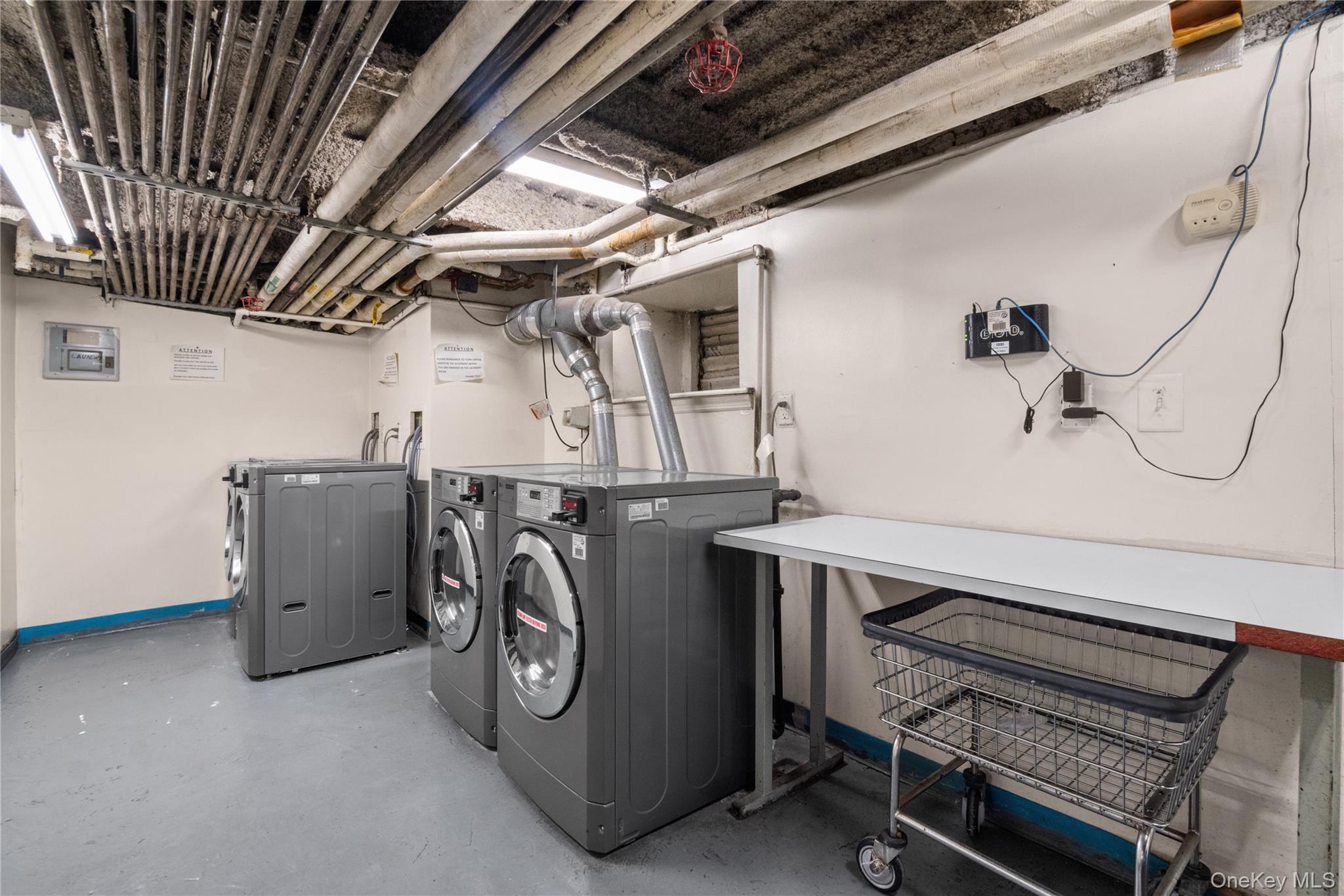 211 West 144th Street, Unit 2C Manhattan, NY 10030 - Photo 13 of 14 Laundry area with separate washer and dryer and baseboards