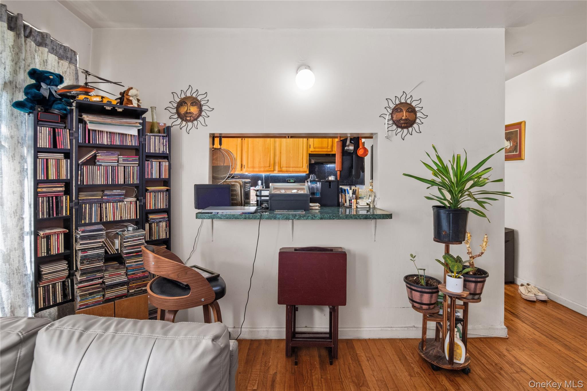 211 West 144th Street, Unit 2C Manhattan, NY 10030 - Photo 3 of 14 Kitchen with wood finished floors, dark countertops, brown cabinetry, a kitchen bar, and range