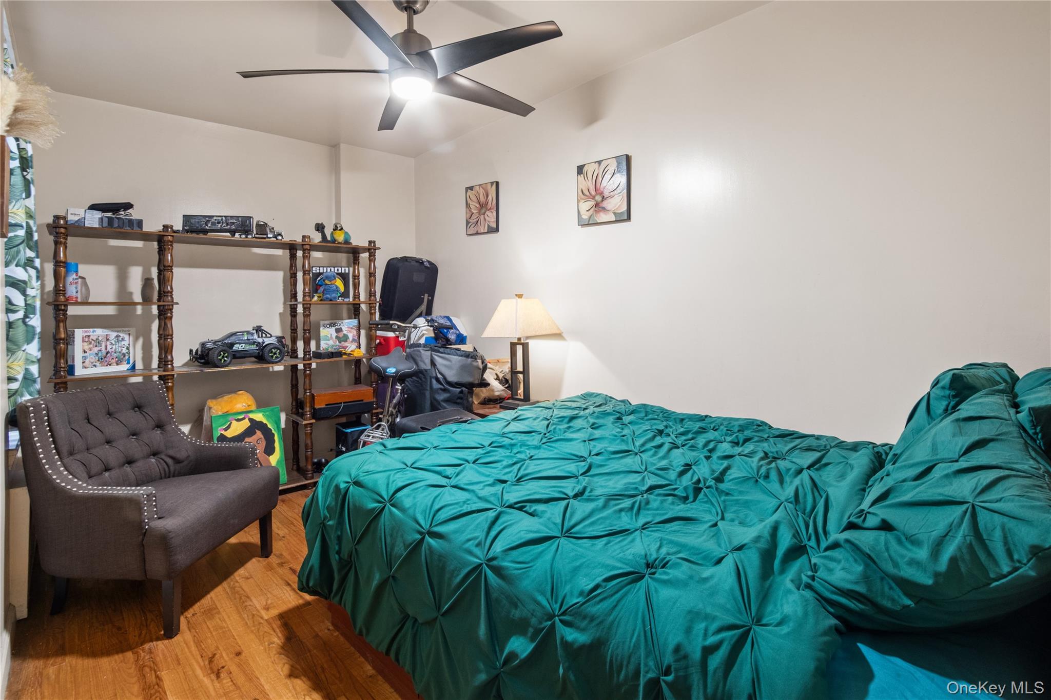 211 West 144th Street, Unit 2C Manhattan, NY 10030 - Photo 7 of 14 Bedroom with wood finished floors and a ceiling fan