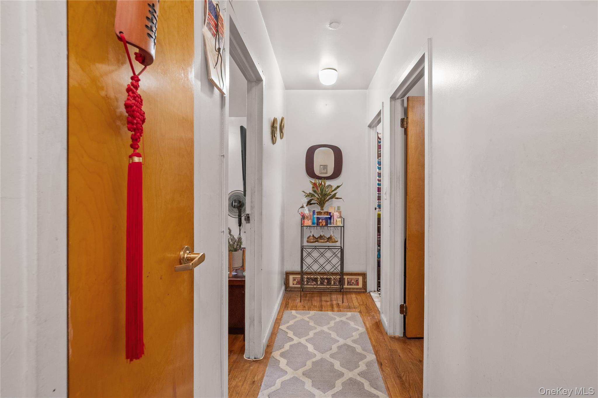211 West 144th Street, Unit 2C Manhattan, NY 10030 - Photo 9 of 14 Hallway featuring light wood-style flooring and baseboards