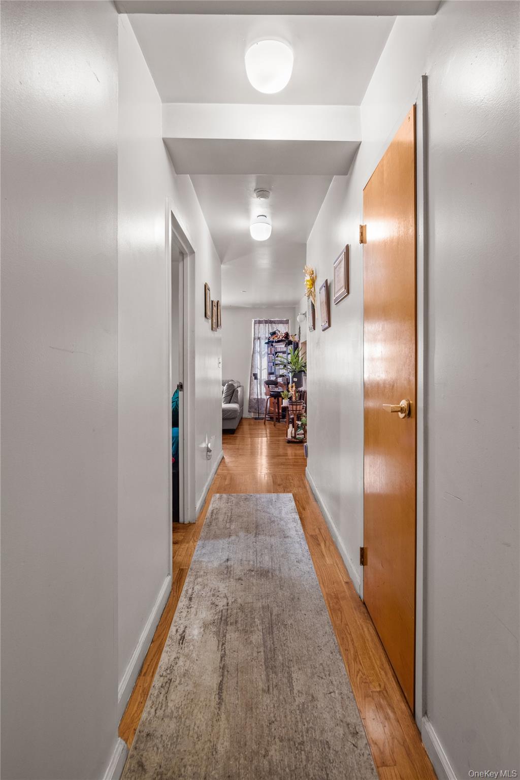 211 West 144th Street, Unit 2C Manhattan, NY 10030 - Photo 10 of 14 Corridor featuring light wood-type flooring and baseboards