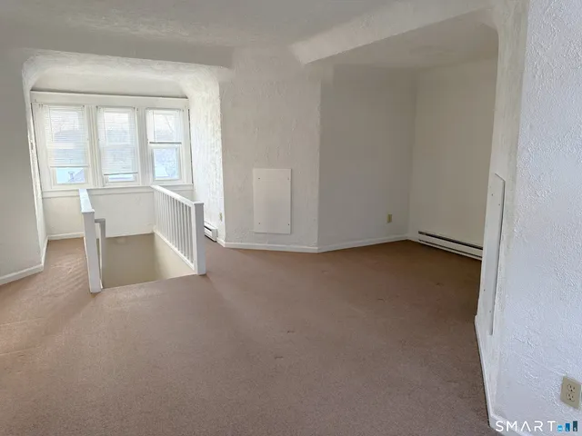 an empty room with a fireplace