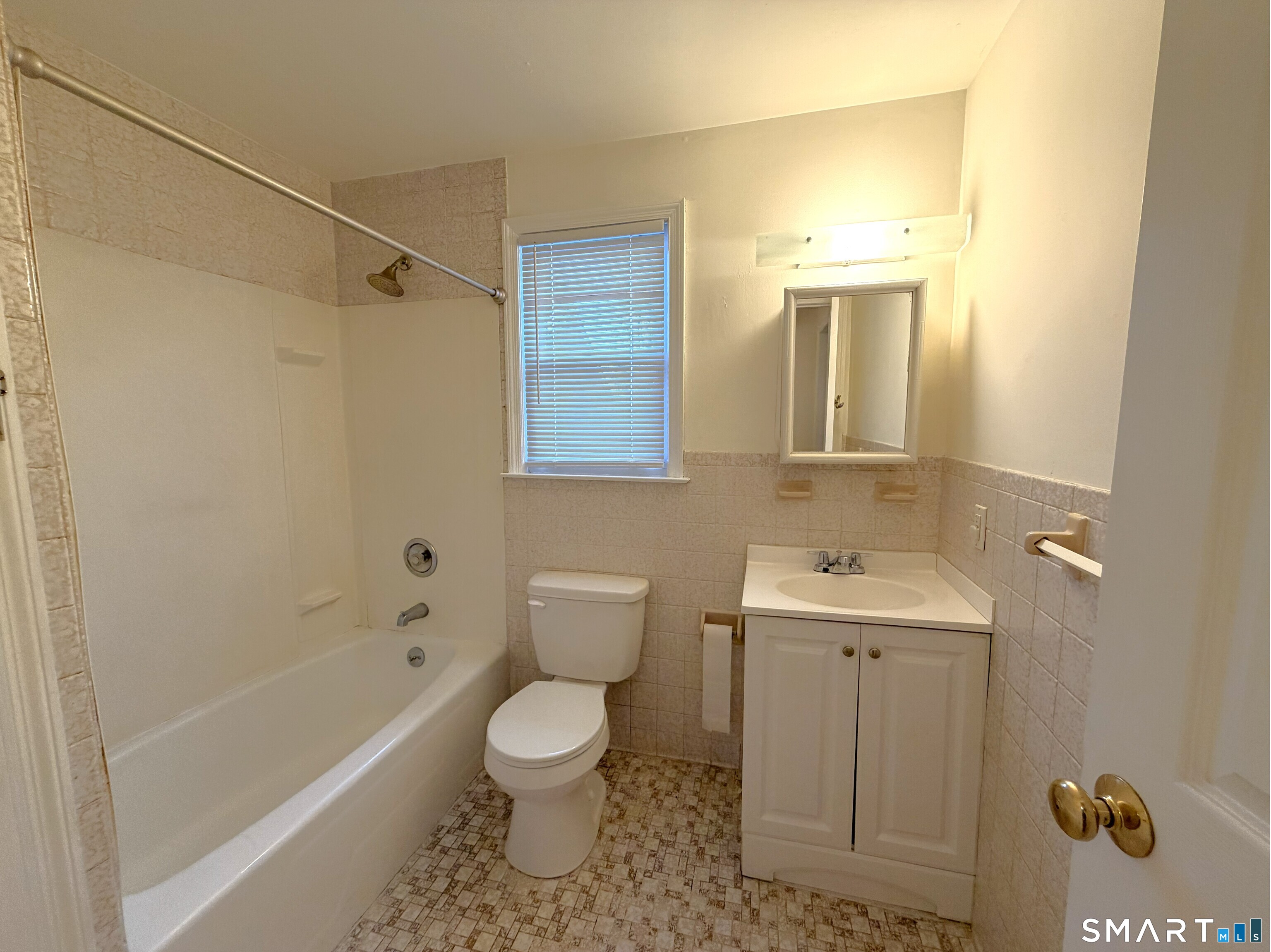 1273 Hope Street, Unit 2 Stamford, CT 06907 - Photo 8 of 14 a bathroom with a sink a toilet and shower