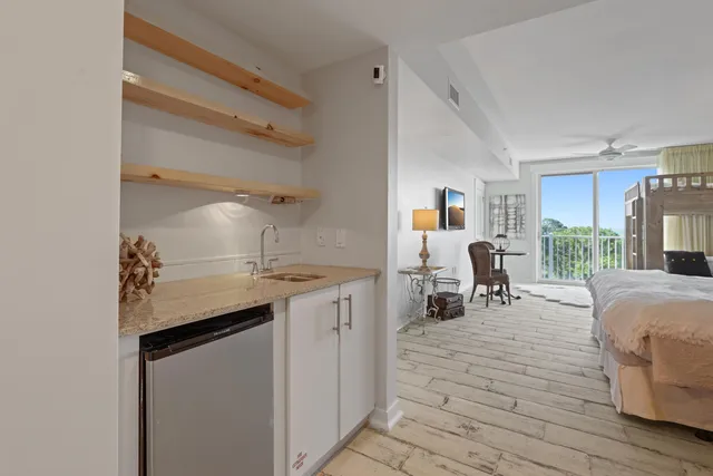 a kitchen with sink refrigerator and cabinets
