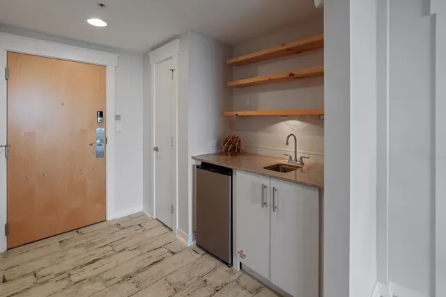 a kitchen with a refrigerator and a sink