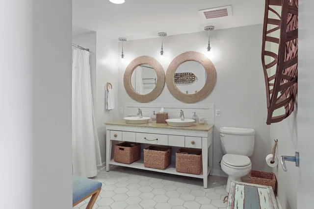 a bathroom with a toilet a sink and a mirror