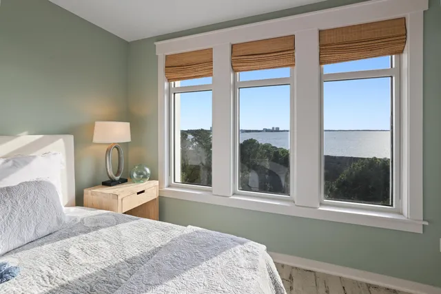 a spacious bedroom with a large bed and a large window