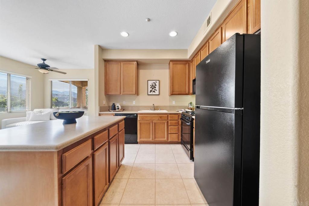 3223 Dehesa Road, Unit 32 El Cajon, CA 92019 - Photo 13 of 46 a kitchen with stainless steel appliances granite countertop a refrigerator a sink and a stove