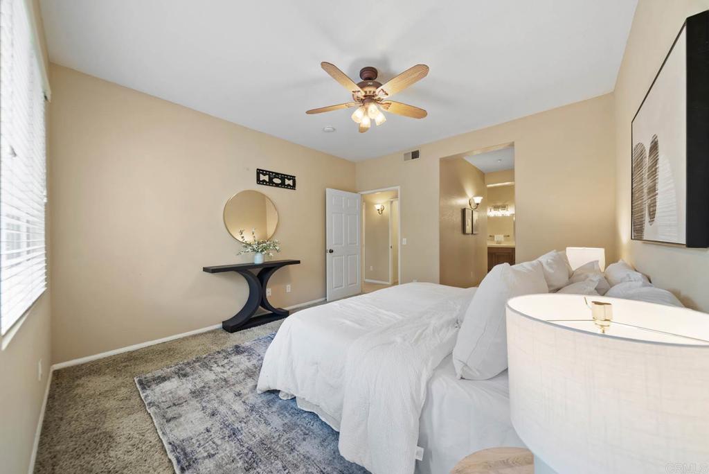 3223 Dehesa Road, Unit 32 El Cajon, CA 92019 - Photo 18 of 46 a bedroom with a bed and a chandelier