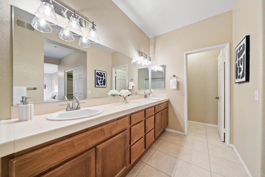 3223 Dehesa Road, Unit 32 El Cajon, CA 92019 - Photo 21 of 46 a spacious bathroom with a double vanity sink and a mirror