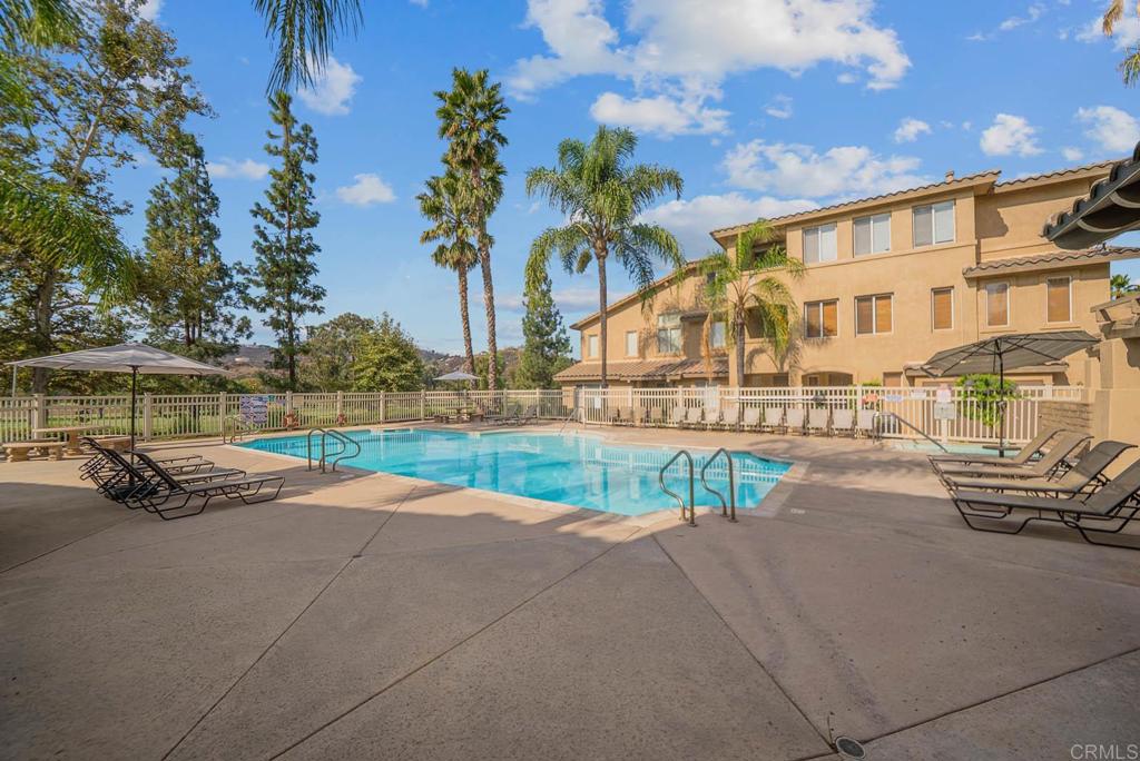 3223 Dehesa Road, Unit 32 El Cajon, CA 92019 - Photo 34 of 46 a view of swimming pool with outdoor seating and house in the background