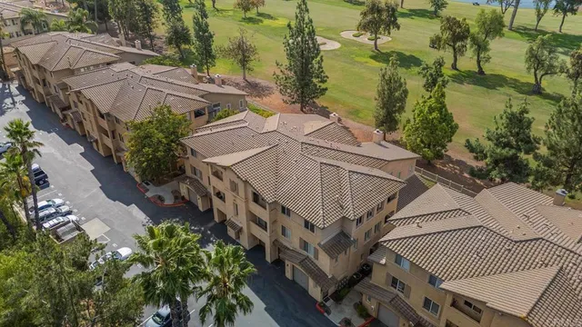 an aerial view of a houses with a street