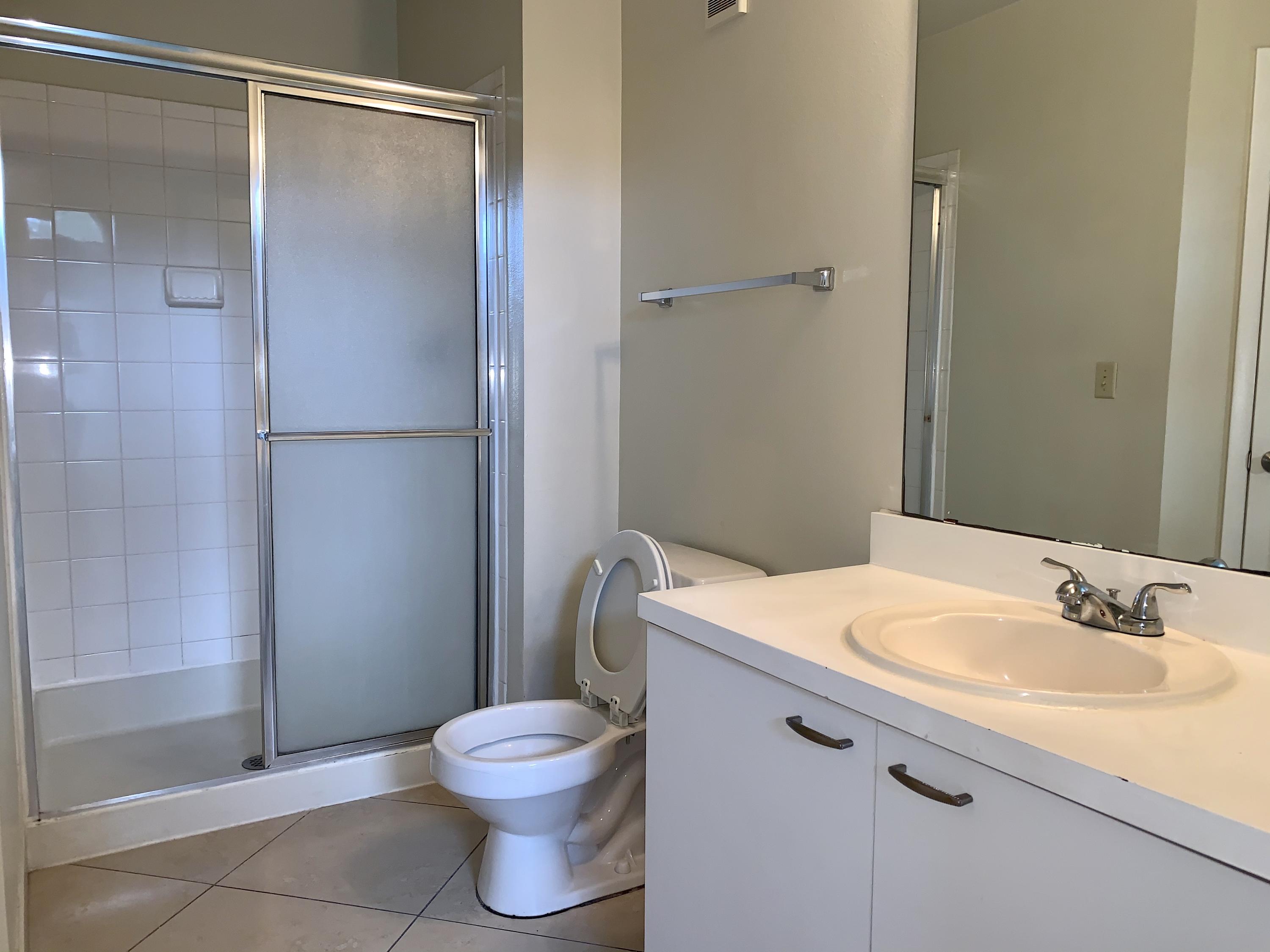 4799 Via Palm Lakes, Unit 1606 West Palm Beach, FL 33417 - Photo 16 of 29 a bathroom with a sink toilet and shower