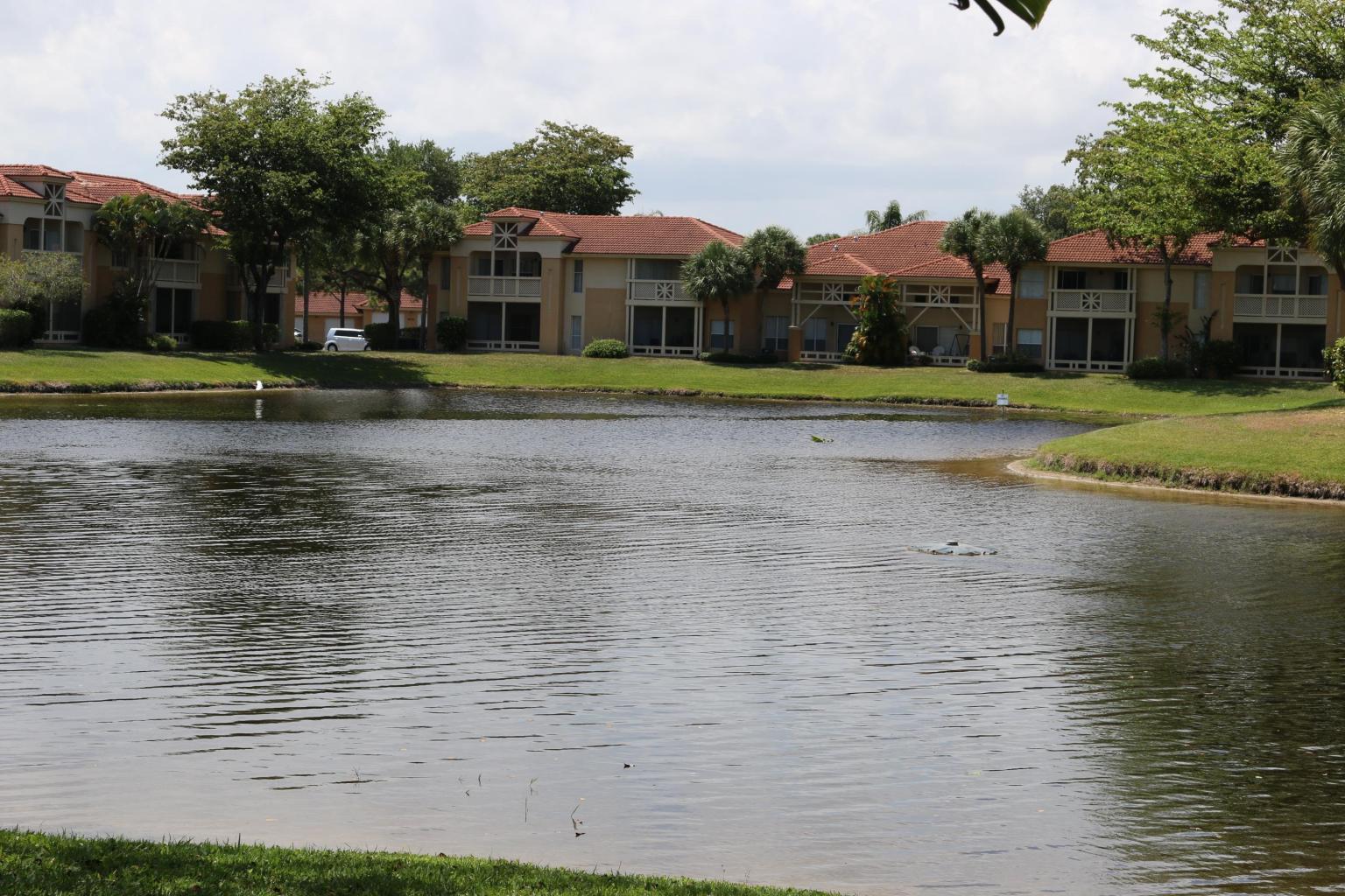 4799 Via Palm Lakes, Unit 1606 West Palm Beach, FL 33417 - Photo 2 of 29 a view of a yard with a house