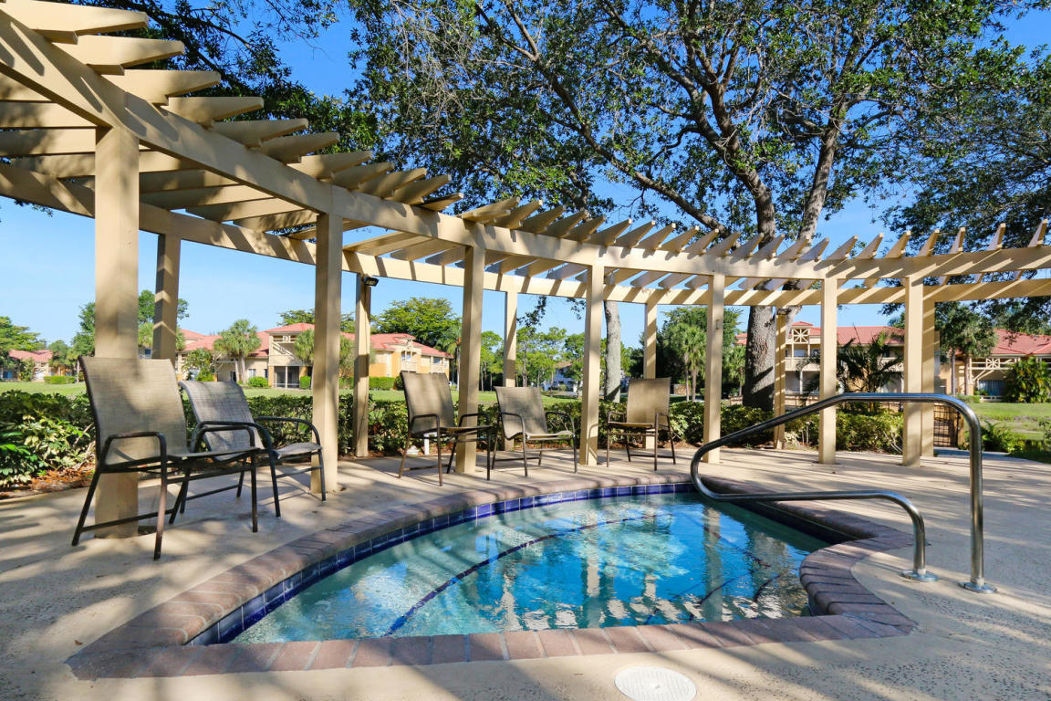 4799 Via Palm Lakes, Unit 1606 West Palm Beach, FL 33417 - Photo 21 of 29 a living room with patio furniture and a large tree