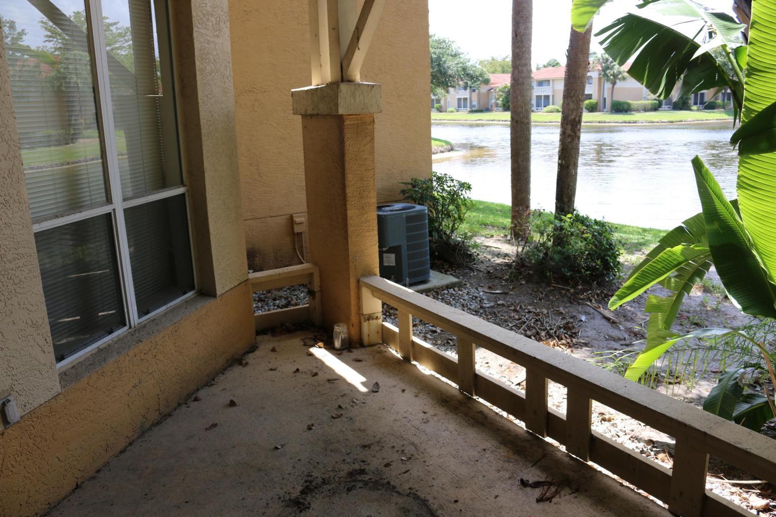 4799 Via Palm Lakes, Unit 1606 West Palm Beach, FL 33417 - Photo 3 of 29 a porch with a table and chairs in patio